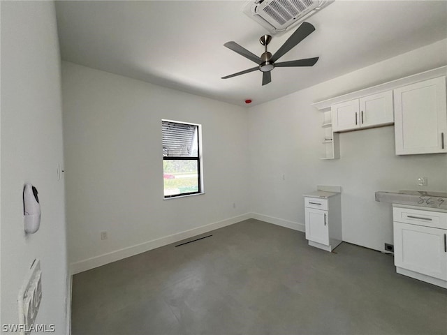 kitchen featuring white cabinets and ceiling fan