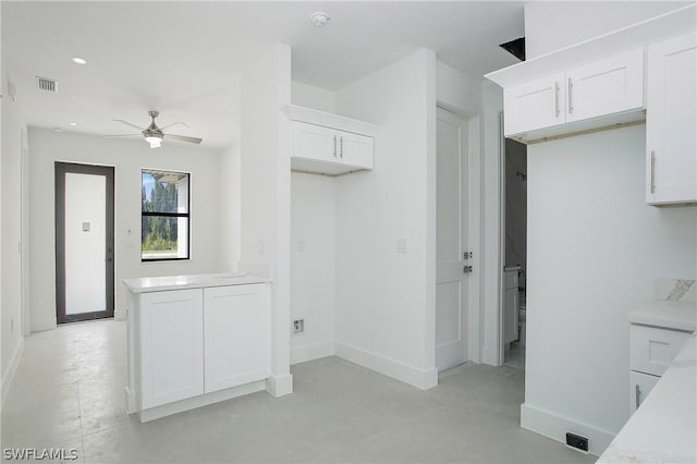 kitchen featuring white cabinetry and ceiling fan