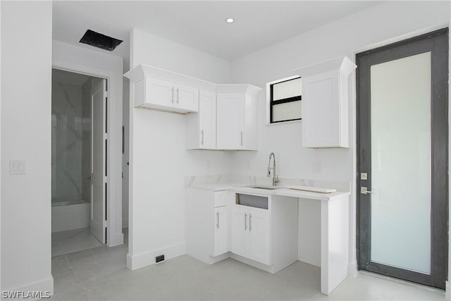 kitchen with white cabinetry and sink