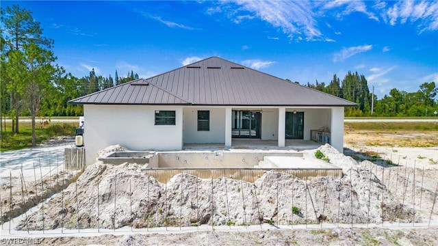 back of property with ceiling fan