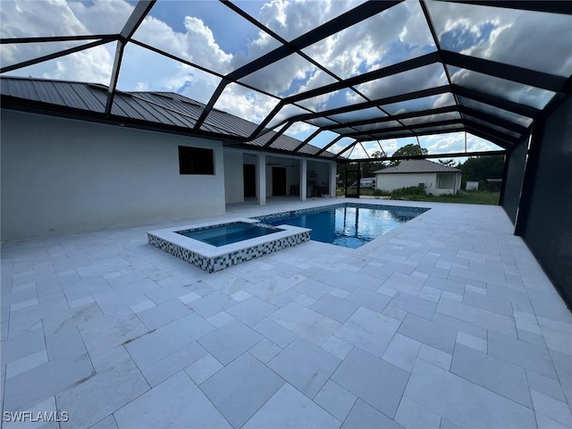 view of swimming pool with an in ground hot tub, glass enclosure, and a patio area