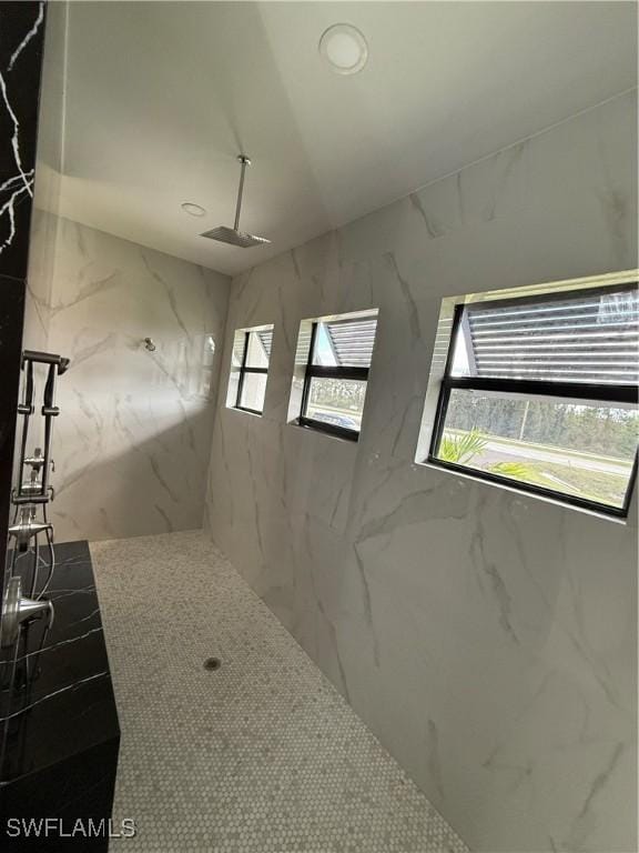 bathroom with a tile shower