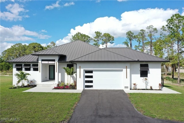 view of front of house featuring a garage and a front yard