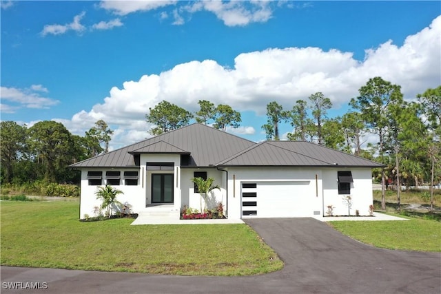 view of front of house with a garage and a front lawn