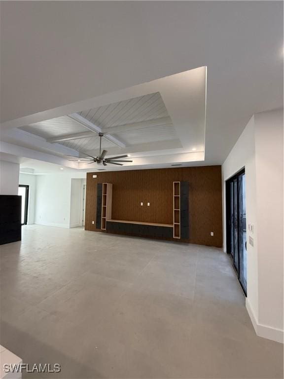 unfurnished living room featuring beamed ceiling, coffered ceiling, and ceiling fan