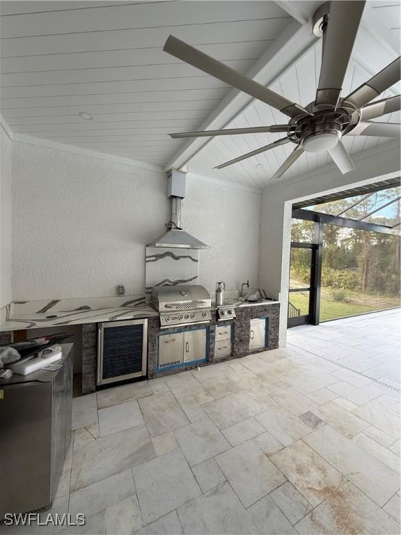 view of patio featuring ceiling fan, area for grilling, a lanai, and wine cooler