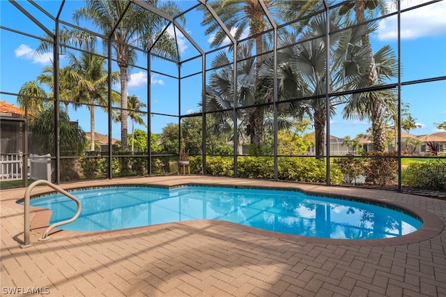 view of pool featuring a patio and glass enclosure