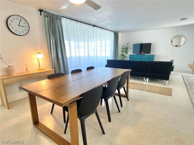 dining room with baseboards, visible vents, and a ceiling fan