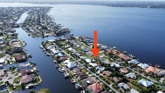 birds eye view of property with a residential view and a water view