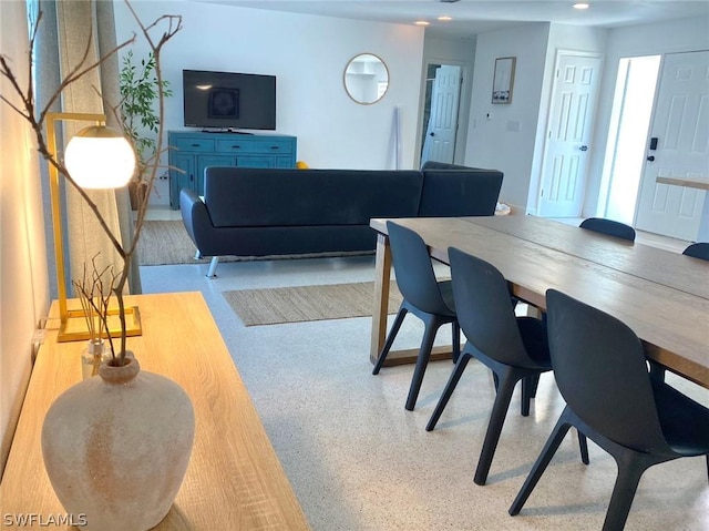 dining space featuring speckled floor and recessed lighting