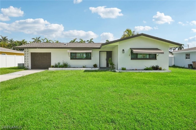 ranch-style house with a garage, fence, driveway, stucco siding, and a front yard