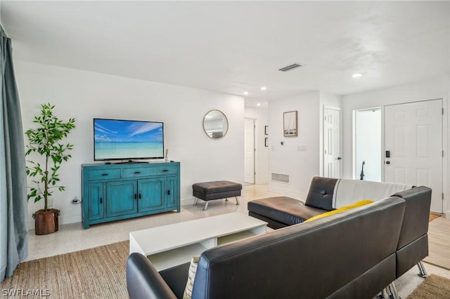 living room with baseboards, visible vents, and recessed lighting