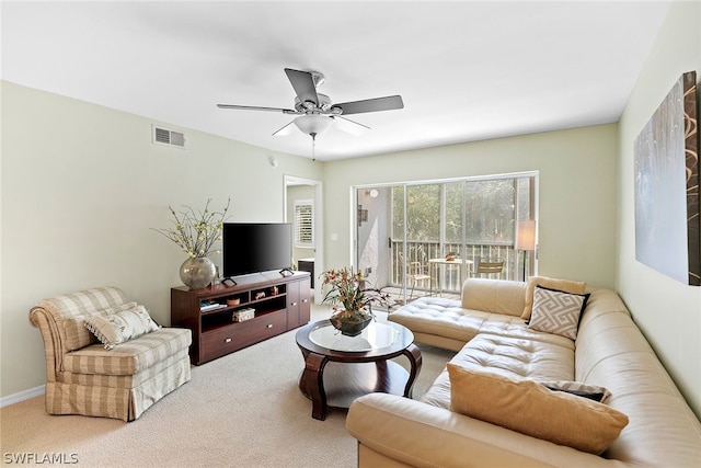 carpeted living room with ceiling fan