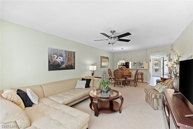 living room with carpet and ceiling fan with notable chandelier