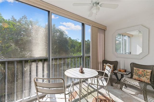 sunroom / solarium featuring ceiling fan