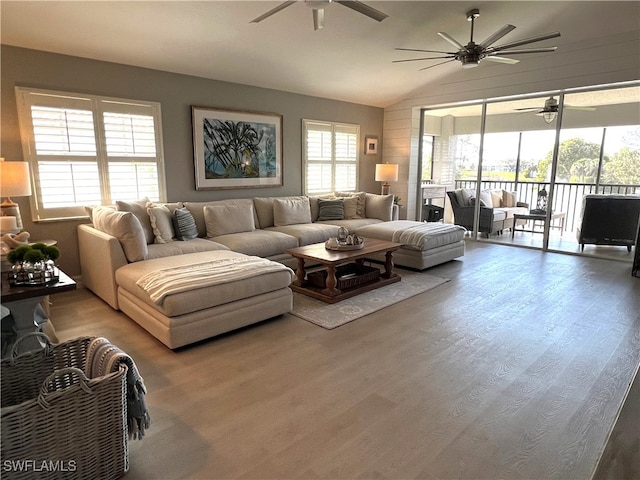 living room featuring hardwood / wood-style floors and vaulted ceiling