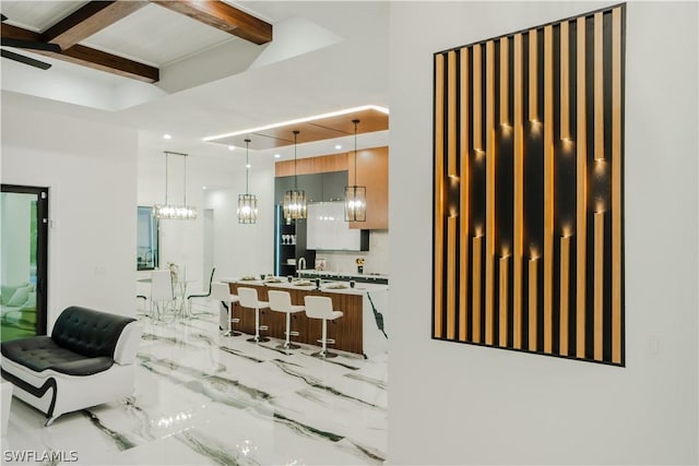 interior space featuring beam ceiling, vanity, and ceiling fan