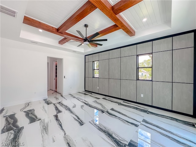 spare room with a tray ceiling, ceiling fan, beam ceiling, and coffered ceiling