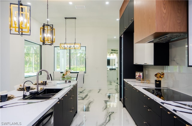 kitchen featuring black electric stovetop, range hood, hanging light fixtures, and sink