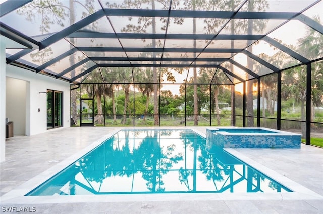 view of pool featuring an in ground hot tub, a patio, and a lanai