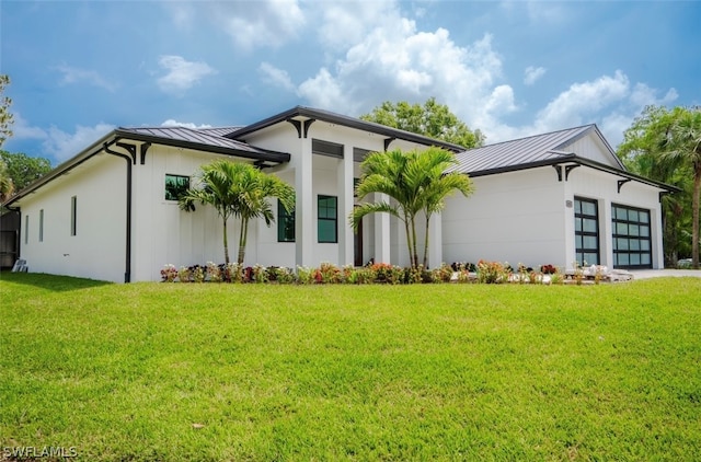 view of front of home featuring a garage and a front lawn