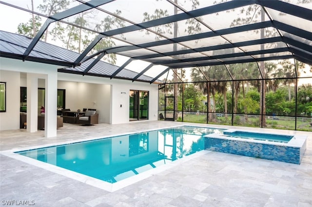 view of pool featuring a lanai, an in ground hot tub, a patio, and an outdoor hangout area