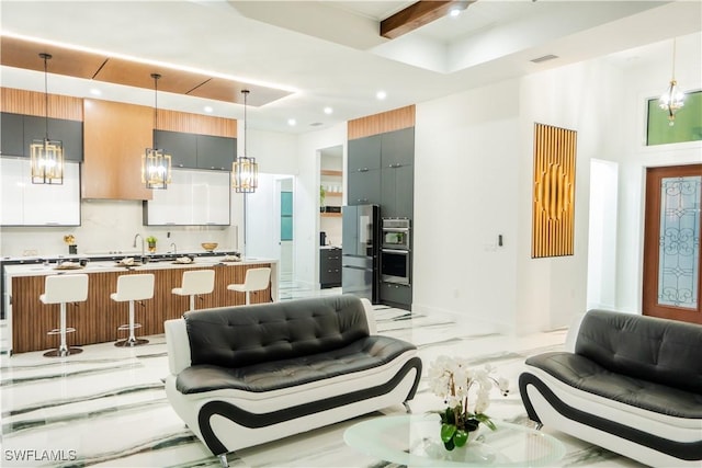 living room featuring beamed ceiling and a tray ceiling