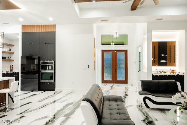 bedroom with black refrigerator, beam ceiling, and french doors