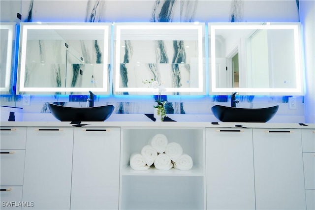 bar featuring decorative backsplash, white cabinetry, and sink