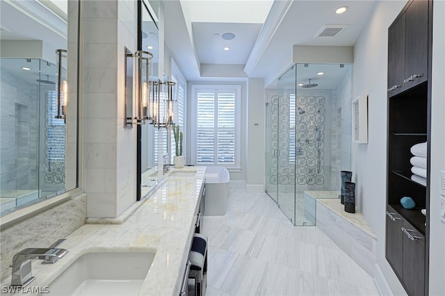 bathroom featuring oversized vanity, dual sinks, a tray ceiling, tile flooring, and walk in shower