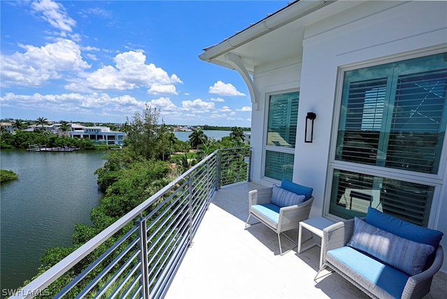 balcony with outdoor lounge area and a water view