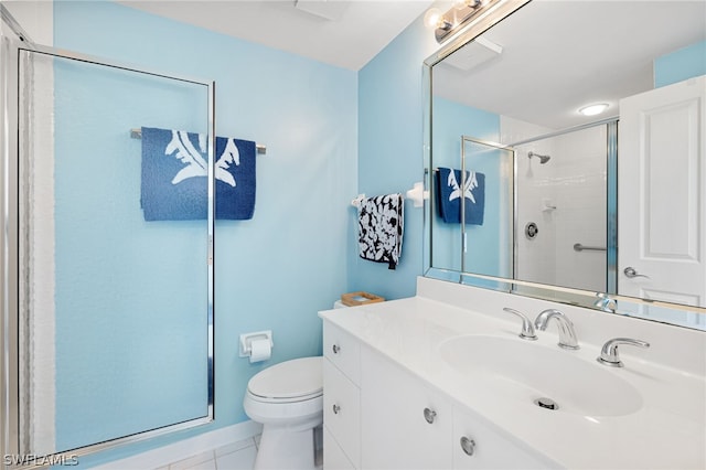 bathroom with toilet, vanity, and an enclosed shower