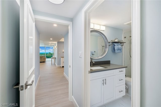 bathroom featuring hardwood / wood-style flooring, vanity, toilet, and walk in shower