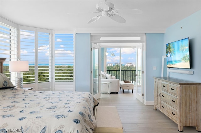 bedroom with multiple windows, light hardwood / wood-style flooring, ceiling fan, and access to exterior