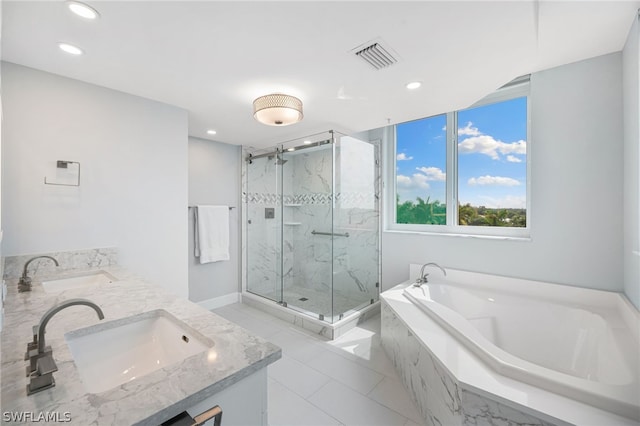 bathroom with vanity and independent shower and bath