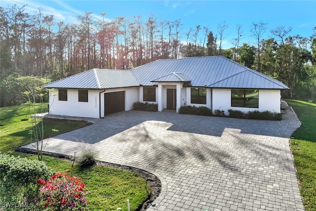 modern farmhouse style home with a garage and a front lawn