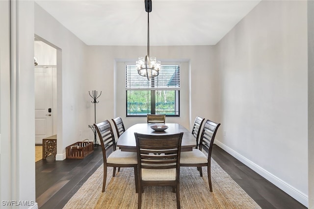 dining space featuring an inviting chandelier and dark hardwood / wood-style flooring