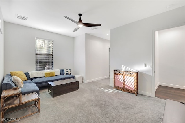 carpeted living room featuring ceiling fan