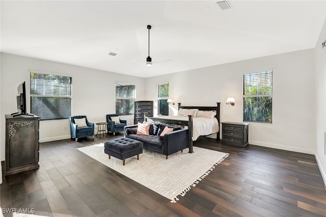 bedroom with ceiling fan, dark hardwood / wood-style flooring, and multiple windows