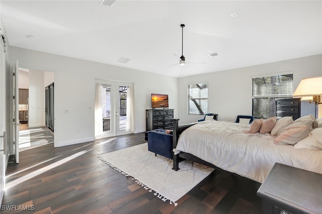 bedroom with dark wood-type flooring, ceiling fan, a barn door, access to outside, and french doors