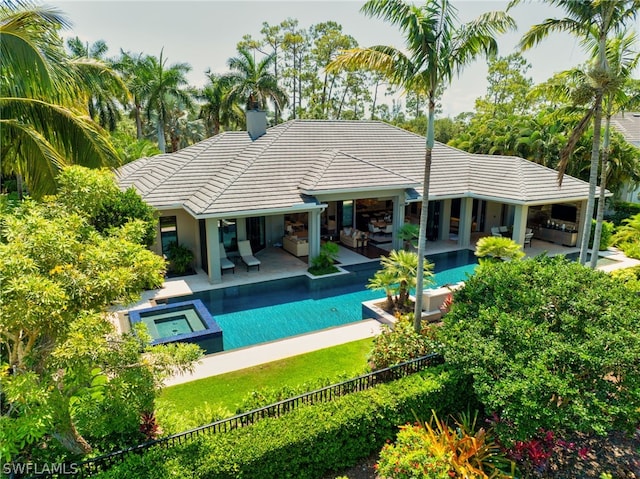 view of swimming pool with a patio area and an in ground hot tub