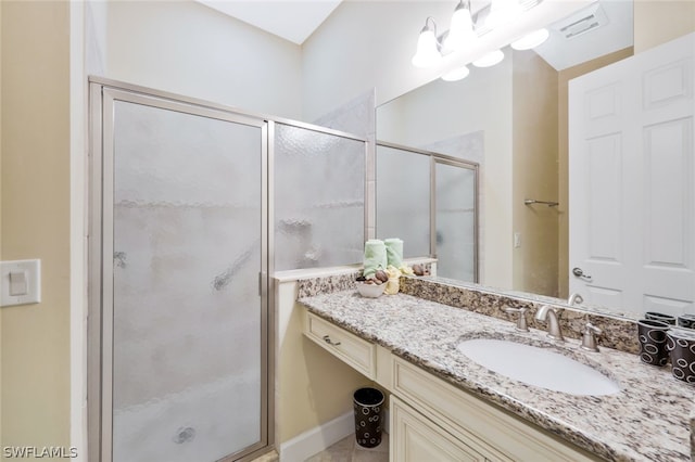 bathroom with vanity and a shower with door