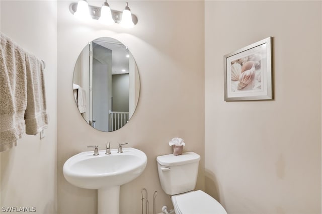 bathroom featuring sink and toilet