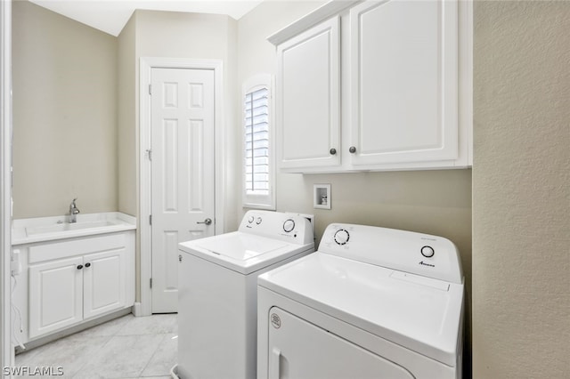 clothes washing area featuring cabinets, separate washer and dryer, light tile patterned floors, and sink