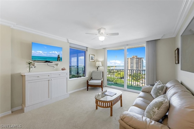 living room featuring light carpet, baseboards, ornamental molding, and ceiling fan