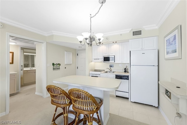 kitchen with white appliances, visible vents, white cabinets, light countertops, and pendant lighting