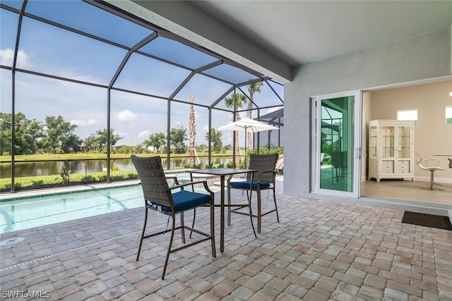 view of patio / terrace with french doors, a water view, and glass enclosure