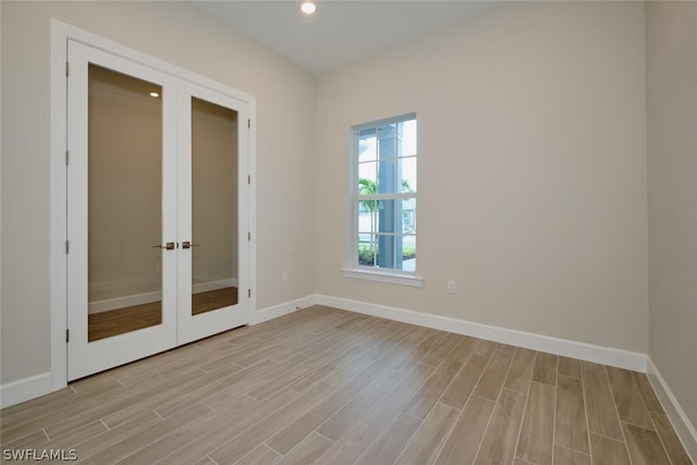 unfurnished room with french doors