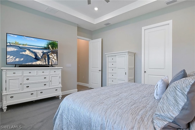 bedroom featuring a tray ceiling and ceiling fan