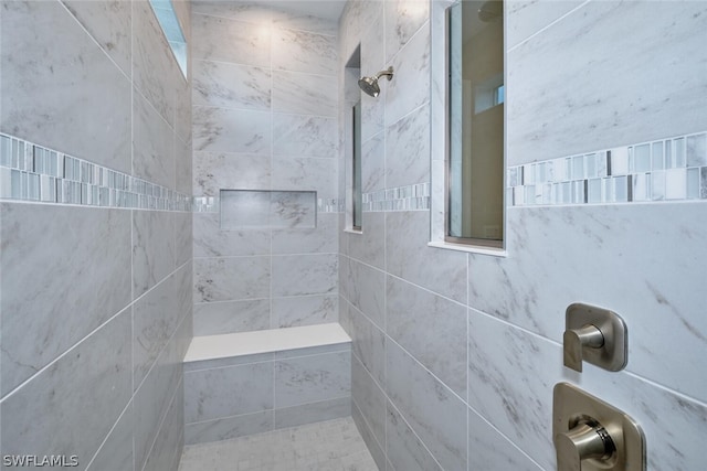 bathroom with tiled shower